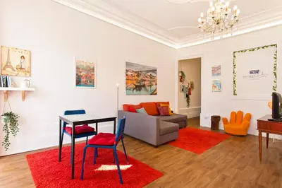 a living room with a table and chairs and a couch at Oporto Blue Cedofeita - Charming Citycenter Loft in Porto