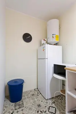 a kitchen with a white refrigerator and a trash can at Oporto Blue Cedofeita - Charming Citycenter Loft in Porto