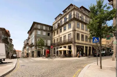 a cobblestone street in a city with tall buildings at Oporto Blue Cedofeita - Charming Citycenter Loft in Porto