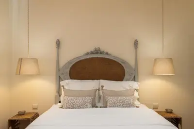 a bedroom with a white bed with two lamps at Gaya Avenue Flats - Elegant Contemporary Flats with Balcony in Vila Nova de Gaia