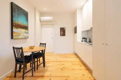 a kitchen and dining room with a table and chairs at HM - Porto Blue Pool Apartment in Porto