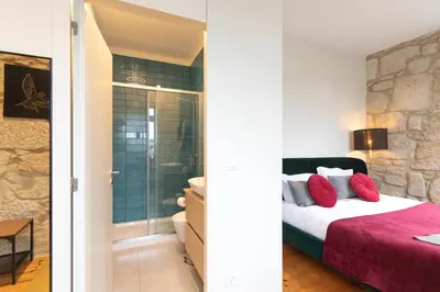 a bedroom with a king sized bed and a bathroom at HM - Porto Blue Pool Apartment in Porto