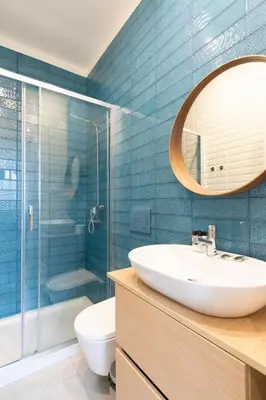 a bathroom with a sink and a glass shower at HM - Porto Blue Pool Apartment in Porto