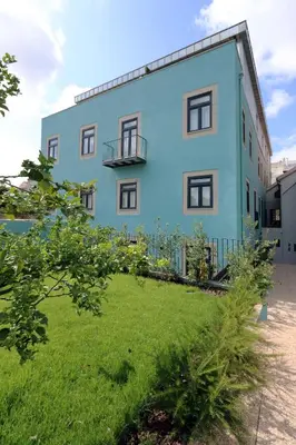 a blue building with a yard in front of it at HM - Porto Blue Pool Apartment in Porto