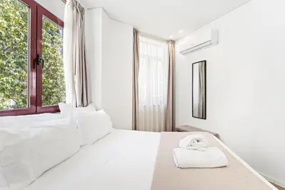 a stack of towels sitting on top of a bed at Alma Invicta Almada in Porto