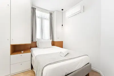 a bed with two towels on it in a window at Alma Invicta Almada in Porto