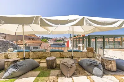 a group of pillows on the ground under an umbrella at Porta Nobre Boutique Hotel by Aspasios in Porto