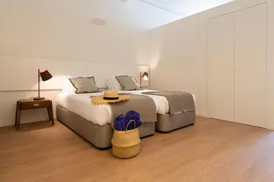 a bedroom with a large bed with a hat on it at bnapartments Cedofeita in Porto