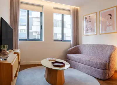 a living room with a couch and a table at Catarina Serviced Apartments by HostWise in Porto