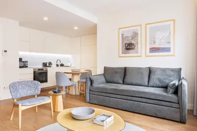 a living room with a couch and a table at Catarina Serviced Apartments by HostWise in Porto