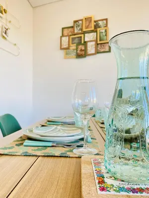 a table with a vase and glasses on it at Douro Eiffel Bridge Amazing View in Vila Nova de Gaia