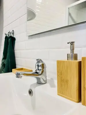 a bathroom sink with a faucet on top of it at Douro Eiffel Bridge Amazing View in Vila Nova de Gaia