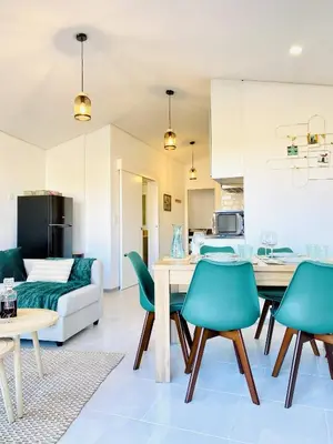 a living room with a couch and a table and chairs at Douro Eiffel Bridge Amazing View in Vila Nova de Gaia