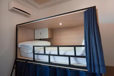 a mirror in a room with two bunk beds at Rosalma Hostel in Porto