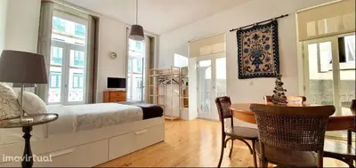 a bedroom with a bed and a table and chairs at Dom Luis apartment in Porto