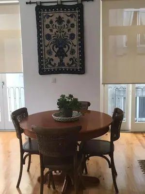 a dining room table with chairs and a picture on the wall at Dom Luis apartment in Porto