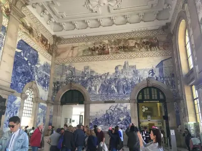a crowd of people in a building with paintings on the wall at Dom Luis apartment in Porto