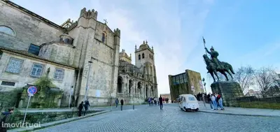a van parked in front of a building with a statue at Dom Luis apartment in Porto