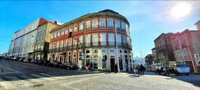 a large building on a city street with cars parked in front at Dom Luis apartment in Porto