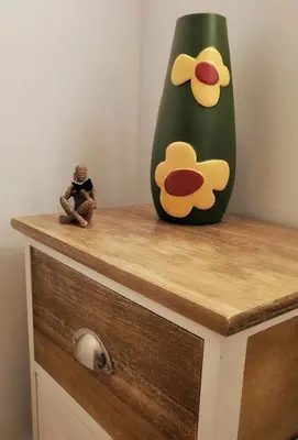 a vase and a doll sitting on a dresser at Flores'Old Town - Elegant studio with roomy patio in Porto