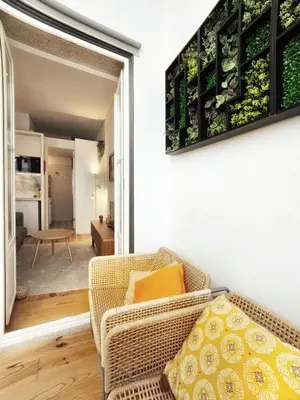 a living room with a chair and a table at Flores'Old Town - Elegant studio with roomy patio in Porto