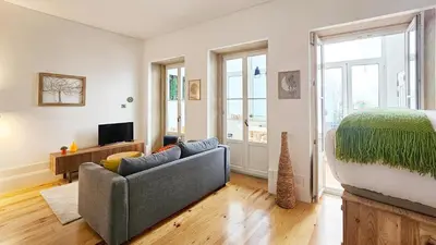 a living room with a couch and a bed at Flores'Old Town - Elegant studio with roomy patio in Porto