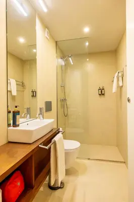 a bathroom with a sink and a toilet and a shower at Casa do Ofício - Livreiro in Porto