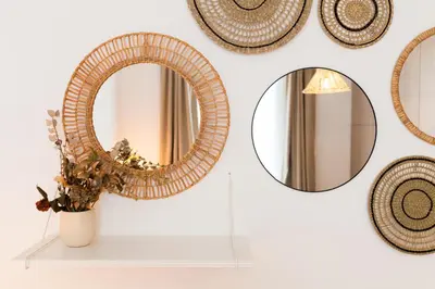 a mirror on a wall next to a vase with a plant at VIVA Miragaia Downtown in Porto