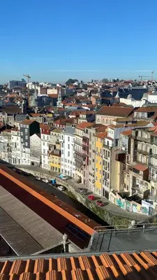 a view of a city with buildings and a train at GET a train and city view in Porto