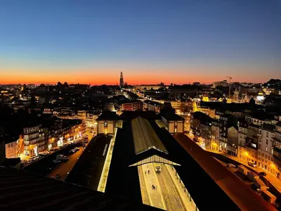 a view of a city at night with lights at GET a train and city view in Porto