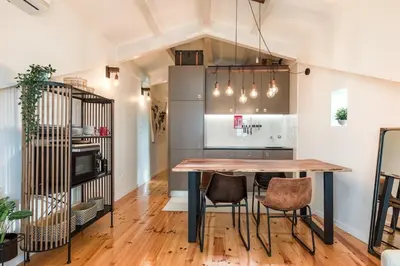a kitchen with a table and chairs in a room at GET a train and city view in Porto