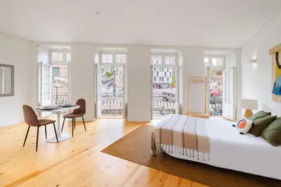 a bedroom with a bed and a table and chairs at InBloom Apartments 2 in Porto