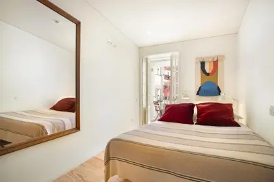 a bedroom with a mirror and a bed at InBloom Apartments 2 in Porto