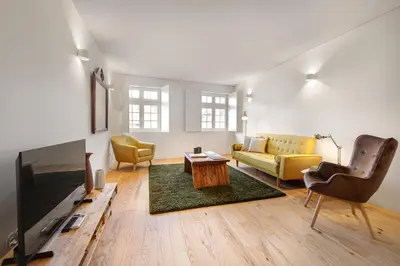 a living room with a couch and a tv at InBloom Apartments 2 in Porto