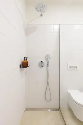 a shower in a white tiled bathroom with a sink at InBloom Apartments 3 in Porto