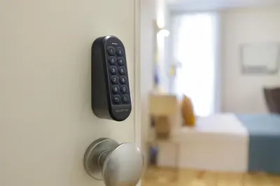a remote control on a door with a bed at InBloom Apartments 3 in Porto