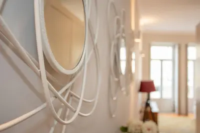 a room with white mirrors on a wall at Liiiving in Porto - Ribeira Secret Apartment in Porto
