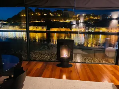 a candle sitting on a table in front of a window at MY DOURO VIEW Luxury Apartment River Front in Vila Nova de Gaia