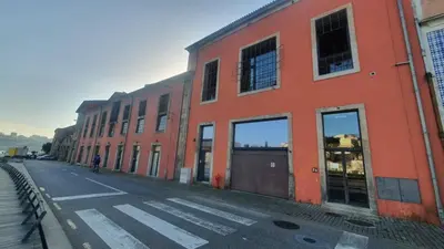 an orange building on the side of a street at MY DOURO VIEW Luxury Apartment River Front in Vila Nova de Gaia