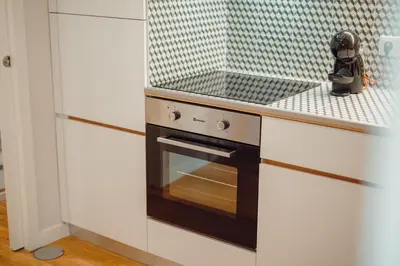 a kitchen with a black and white stove top oven at River Eyes Apartments in Porto
