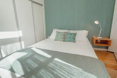 a bedroom with a white bed with two pillows at River Eyes Apartments in Porto