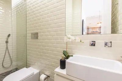a bathroom with a sink and a toilet and a mirror at In Between Exclusive Charm Apartment by the center in Porto