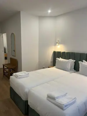 a bedroom with a large bed with towels on it at ORM- Flores Apartment in Porto