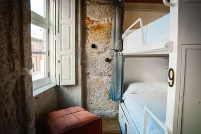 a small room with a bed and a window at The Central House Porto Ribeira in Porto