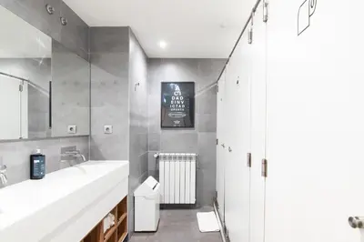 a bathroom with a white sink and a mirror at The Central House Porto Ribeira in Porto