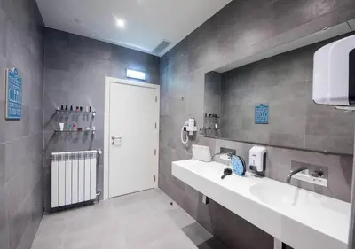 a bathroom with two sinks and a white door at The Central House Porto Ribeira in Porto