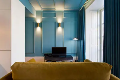a living room with blue walls and a yellow couch at BOUTIQUE Rentals-Kinga’s Ribeira River great views in Porto