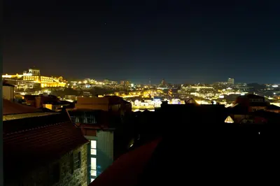 a view of a city at night with lights at BOUTIQUE Rentals-Kinga’s Ribeira River great views in Porto