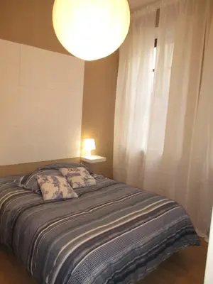 a bedroom with a bed with a lamp and a window at Oportobestview-Douro in Porto