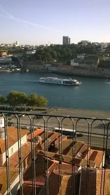 a boat in the water with a cruise ship at Oportobestview-Douro in Porto